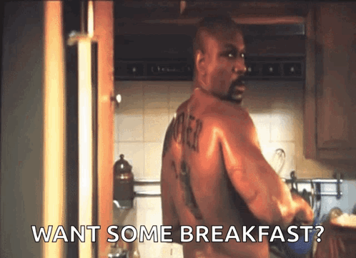 Man in Kitchen Saying Want Some Breakfast