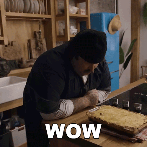 Man in Kitchen With Casserole Dish Wow