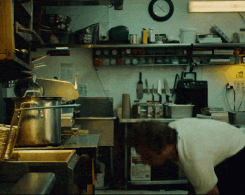 Man in Kitchen with Clock