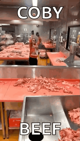 Man in Kitchen with Meat Conveyor