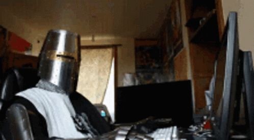 Man in Knight Helmet at Computer