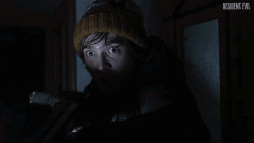 Man In Knitted Hat Looking In Dark Resident Evil GIF