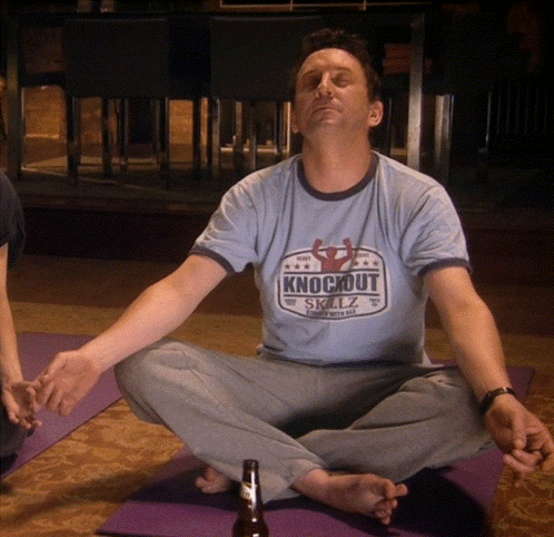 Man in Knockout Shirt on Yoga Mat