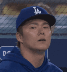 Man In LA Dodgers Hat Looks At Something GIF