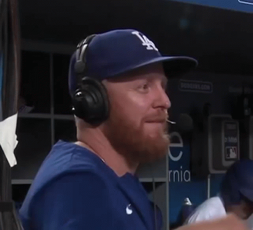 Man In LA Hat And Headphones Talking Into Microphone GIF