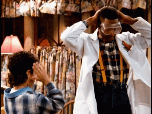 Man in Lab Coat and Goggles Next to Girl