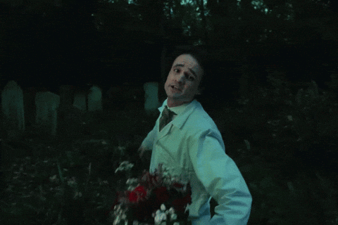 Man in Lab Coat and Tie Dancing in Dark