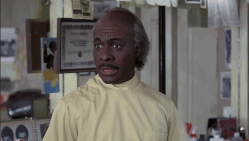 Man In Lab Coat By Framed Certificate GIF