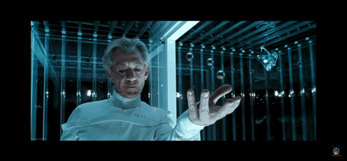 Man In Lab Coat Holding Something In Dark Room GIF