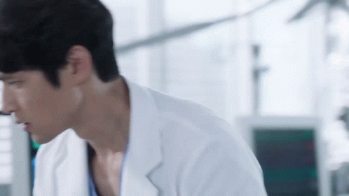Man in Lab Coat Looking Down