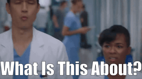 Man in Lab Coat Next to Woman in Scrubs