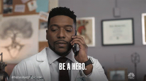 Man in Lab Coat on Cell Phone Saying Be a Hero