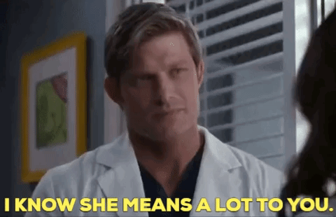 Man in Lab Coat Talking to Woman