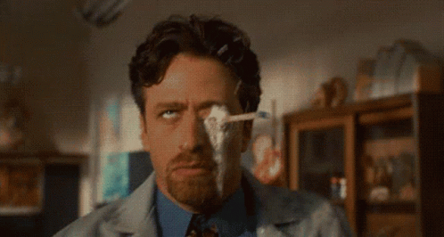 Man In Lab Coat Wiping Eye With Tissue GIF