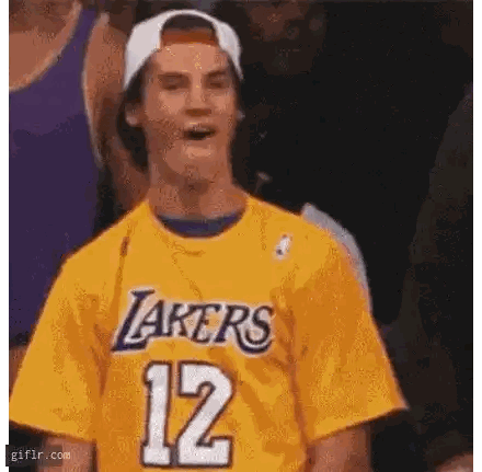 Man in Lakers Jersey and Cap Making Funny Face