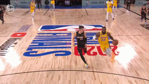 Man in Lakers Jersey Dribbling Ball