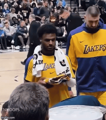 Man in Lakers Jersey Walking on Court