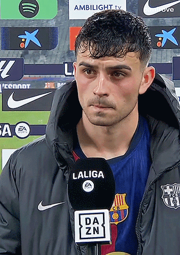 Man in Laliga Jacket Talking Into Microphone
