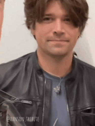 Man in Leather Jacket and Blue Shirt