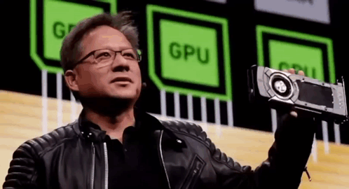 Man in Leather Jacket and Glasses Holding GPU