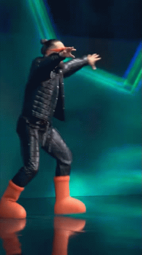 Man in Leather Jacket and Orange Boots Dancing