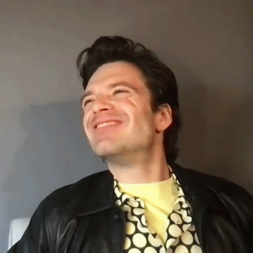 Man in Leather Jacket and Yellow Shirt Smiling