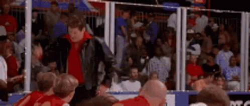 Man in Leather Jacket at Basketball Game
