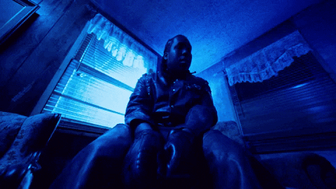 Man In Leather Jacket At Blue Window GIF