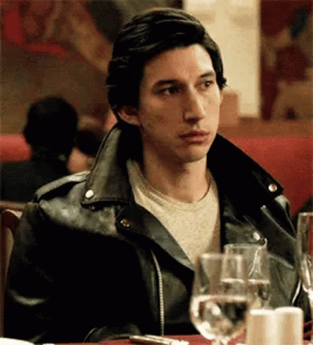 Man In Leather Jacket At Table With Wine Glasses GIF