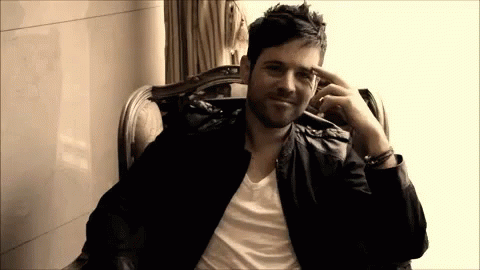 Man In Leather Jacket Hand To Forehead GIF