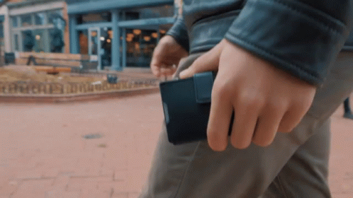 Man in Leather Jacket Holding Black Wallet