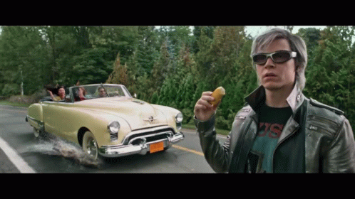 Man In Leather Jacket Holding Donut In Front Of Car With NC 88 License Plate GIF