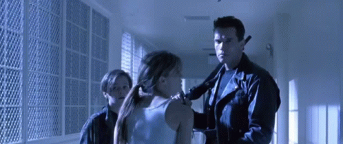 Man in Leather Jacket Holding Gun Next to Woman and Boy