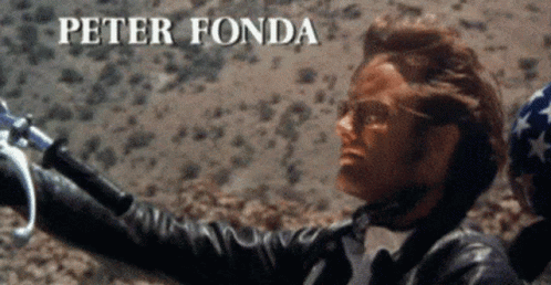 Man In Leather Jacket Holding Motorcycle Handlebars Peter Fonda GIF