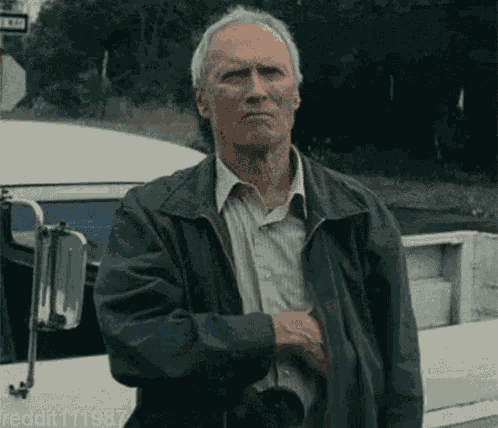 Man in Leather Jacket in Front of Bus