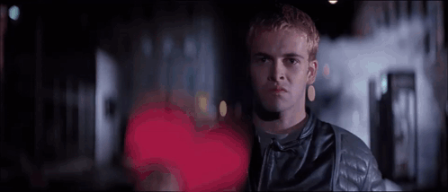 Man in Leather Jacket in Front of Red Heart