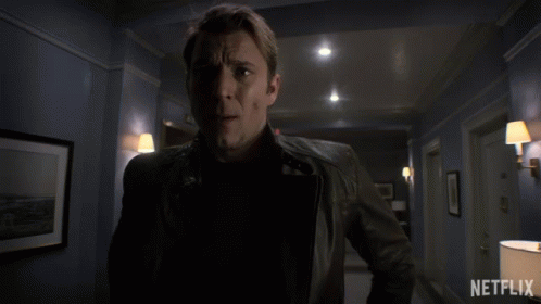 Man in Leather Jacket in Hallway With Netflix