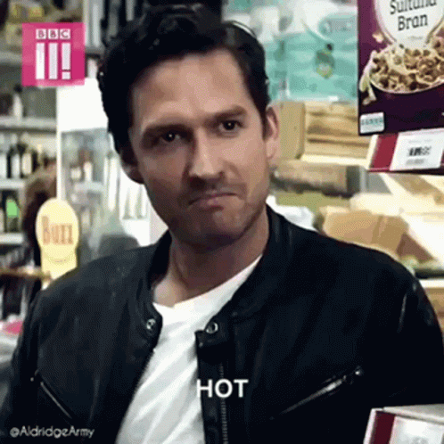 Man in Leather Jacket Making Face in Grocery Store