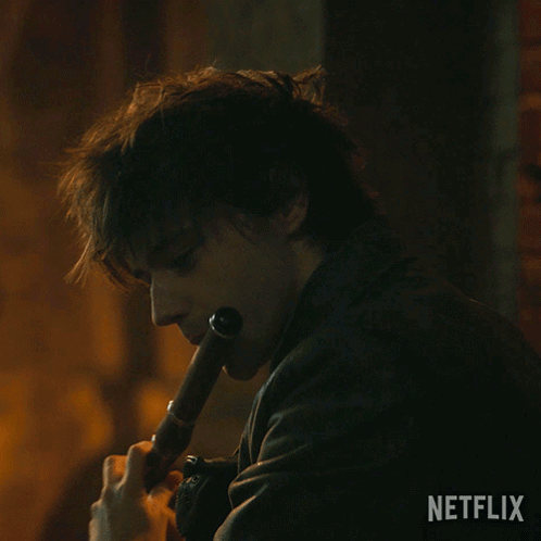 Man In Leather Jacket Playing Flute With Netflix Logo GIF