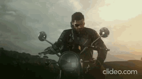 Man In Leather Jacket Riding Motorcycle In Countryside GIF