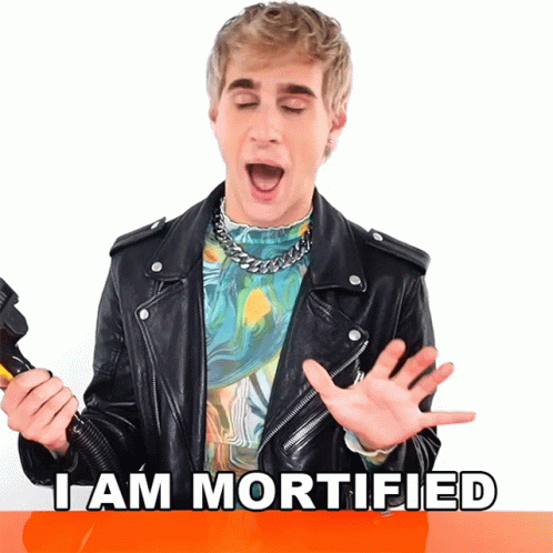 Man In Leather Jacket Says I Am Mortified Holding Microphone GIF