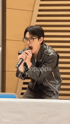 Man in Leather Jacket Singing into Microphone