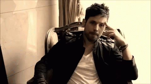 Man in Leather Jacket Sitting Hand on Head