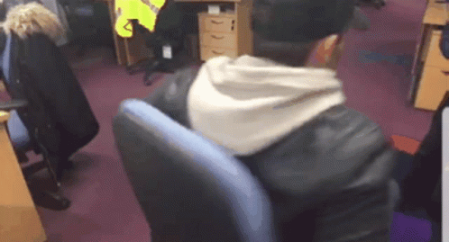 Man in Leather Jacket Sitting in Blue Chair
