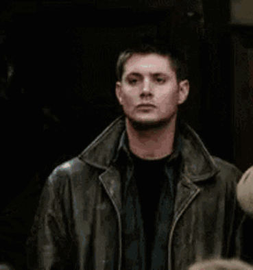 Man in Leather Jacket Standing Beside Another Man