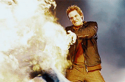 Man in Leather Jacket Standing by Fire