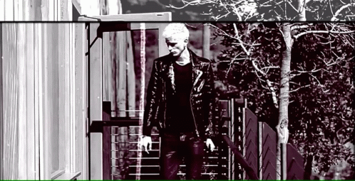 Man in Leather Jacket Walking Down Stairs