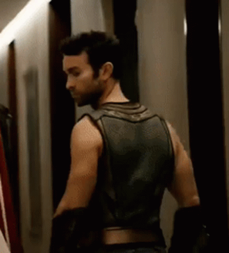 Man in Leather Vest Standing in Hallway
