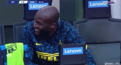 Man in Lenovo Shirt Sitting in Locker Room