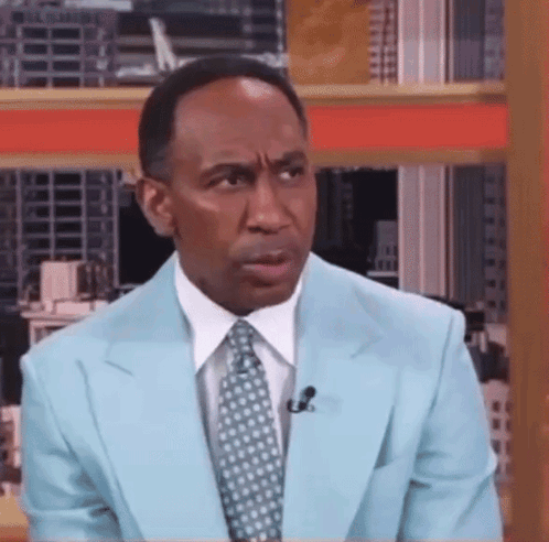Man in Light Blue Suit With Microphone